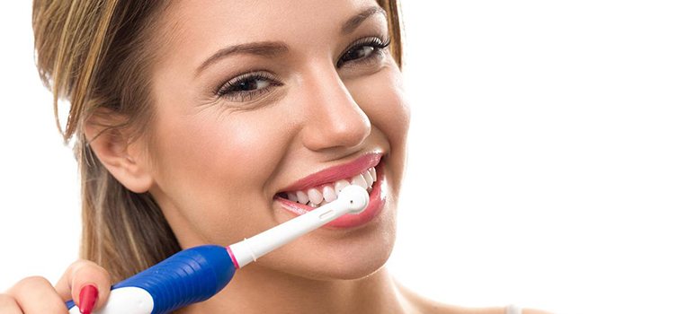 A woman brushes her teeth